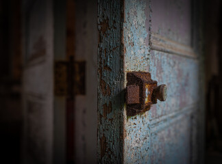 Close up of a rusty door latch in an abandoned house