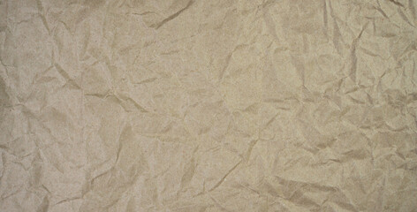 Crumpled brown paper. Banner. Top view. Copy space. Selective focus.