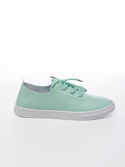 Leather sport shoe on a white background. Isolated turquoise sneaker with shadow
