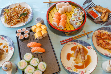 Composition des plats japonais, servie sur fond rustique foncé, vue de dessus. Ensemble de cuisine japonaise. Assortiment de sushi. Buffet à volonté