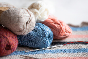 Balls of knitting yarn on knitted fabric