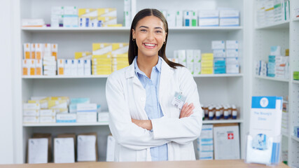 Portrait of a cheerful and friendly pharmacist using a digital tablet to check inventory or online...