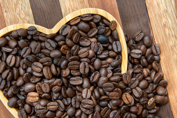 coffee beans in heart-shaped tra,y representing love of coffee