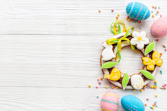 Easter sweet wreath made of bunny and eggs cookies, top view