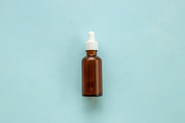 Essential serum oil in dropper bottle with pipette, top view