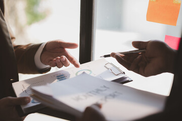 The sales department is having a monthly summary meeting to bring it to the department manager, they are verifying the correctness of the documents that are prepared before bringing in to the manager
