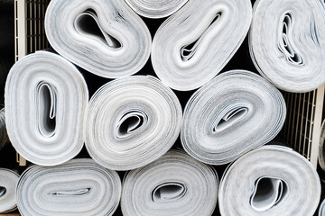 Foil insulation in rolls in the warehouse of a hardware store. Trade in building materials for saving energy and keeping warm. Close-up