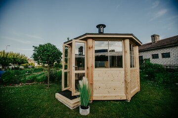 Wooden conceptual project of tiny house with transparent glass walls