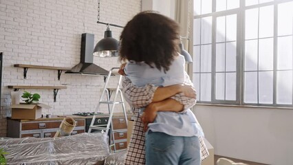 Happy loving husband lifts his wife, circles her, shares happiness, moving into new own apartment - Powered by Adobe