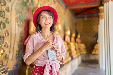 portraity of pretty smiling thai woman at wat arun temple in bangkok thailand