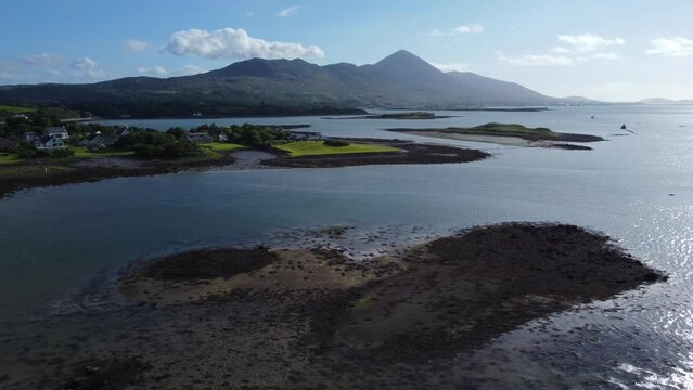 Beautiful tracking aerial over water of Croagh Patrick mountain in Ireland