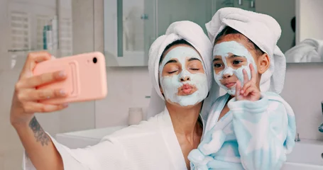 Fotobehang Badkamer Beauty, skincare and facial with mother and girl and selfie in bathroom for health, spa and wellness. Luxury, product and mask on face with mom and child in family home for happy, peace and relax  © Kirsten D/peopleimages.com