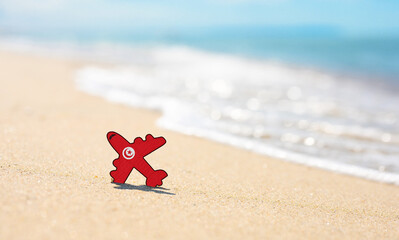 Vacation on the coast of Tunisia. Airplane in the colors of the flag of Tunisia on the seashore