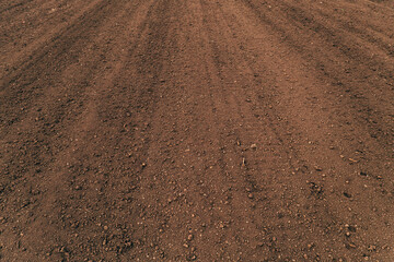 Ploughed soil in perspective as background
