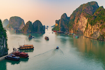 Sunset over the halong bay, Boats in a body of water with mountains in the background, Boats in a...