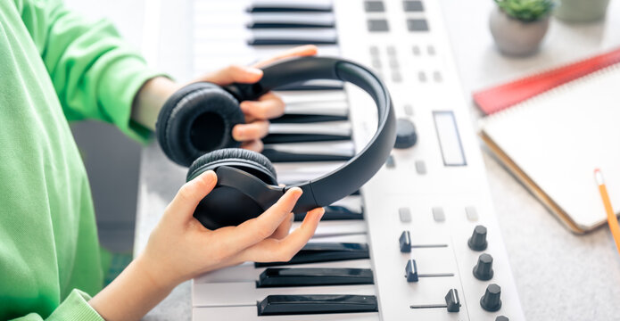 Close-up, black headphones in the hands of a child, music concept.