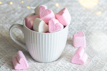 Cup with marshmallows in the form of hearts, close-up.