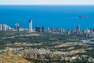 skyscrapers, apartment buildings and hotels with the sea in the background. Dense buildings of the city of Benidorm, seen from above. Blue sky, horizontal