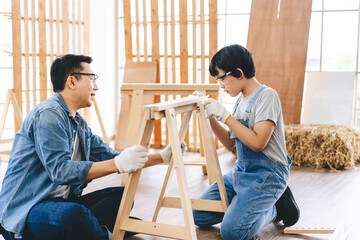 Southeast asian family father and son diy or repair for crafts skill at home workshop