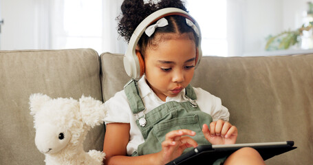 Tablet game, headphones and relax child gaming, having fun or play online games on mobile device or...