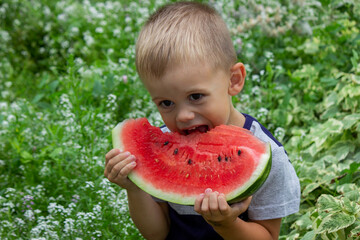 A child eats a watermelon. Selective focus.