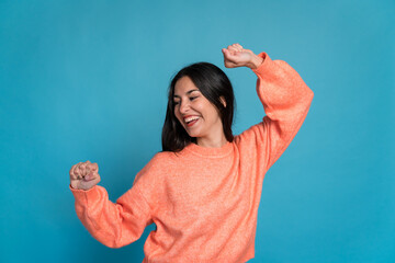Cheerful woman celebrating victory and dancing