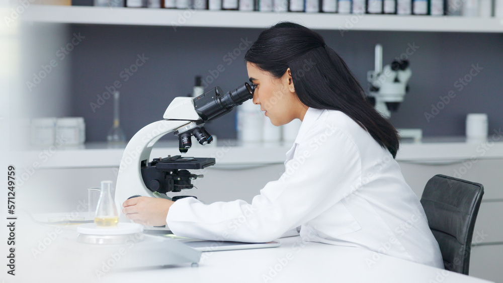 Poster Young scientist using a digital tablet and microscope in a lab. Female pathologist analyzing medical samples while doing experiments to develop a cure. Microbiologist conducting forensic research