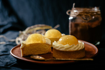 Lemon tartlets on a black background. An exquisite European dessert with fruit filling.