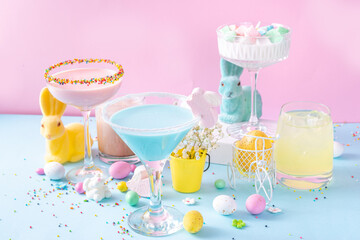 Colorful pastel colored kids Easter party mocktails, Creamy and iced non-alcohol drinks with cotton...