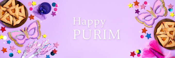 Purim carnival background with traditional cookies, costume accessories and decor on pastel violet
