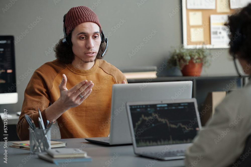 Poster young confident male operator of helpdesk or it support manager with headset answering questions of 