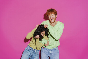 Obraz premium White young man and woman hugging and laughing at camera