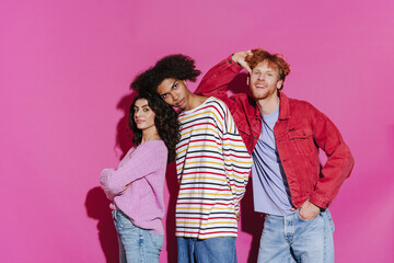 Young beautiful stylish international friends posing