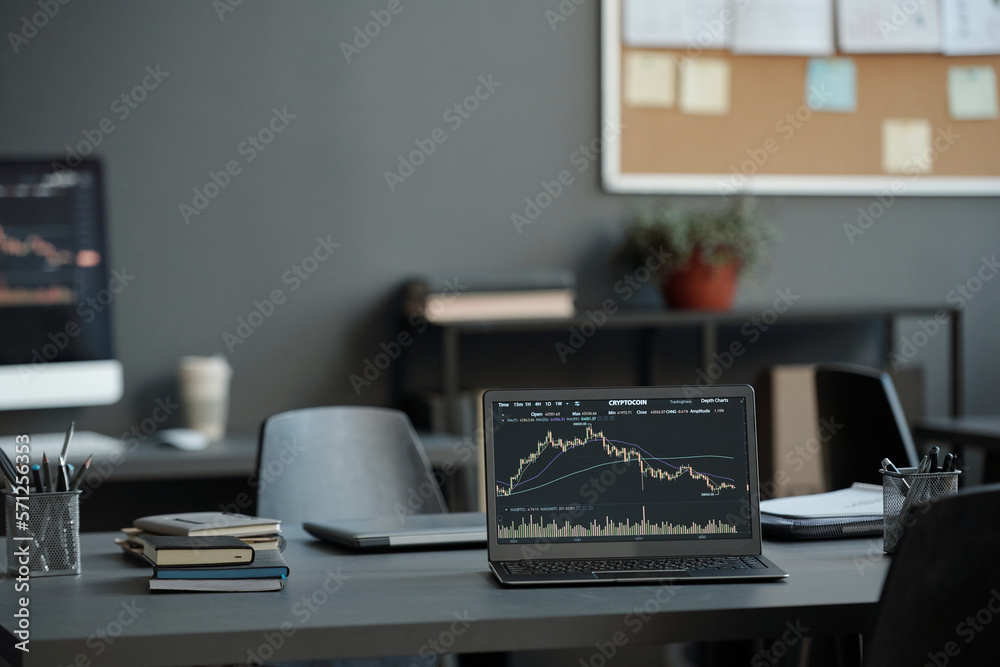 Fototapete Laptop with graphic financial data on screen standing on desk which is workplace of analyst creating illustrations of market development