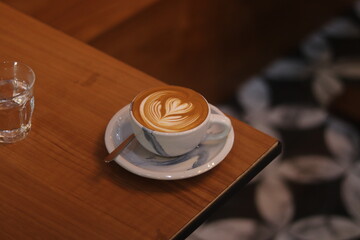 latte art on the wood table in the coffee shop