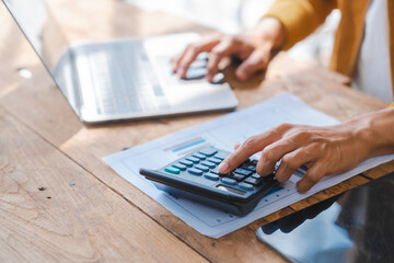 Young asia husband calculate household expenses and financial document on table, using laptop, balance sheet, work at home concept.