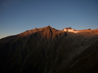 Alpine mountain sunset panorama of Mount Armstrong summit glacier seen from Brewster Hut track Southern Alps New Zealand
