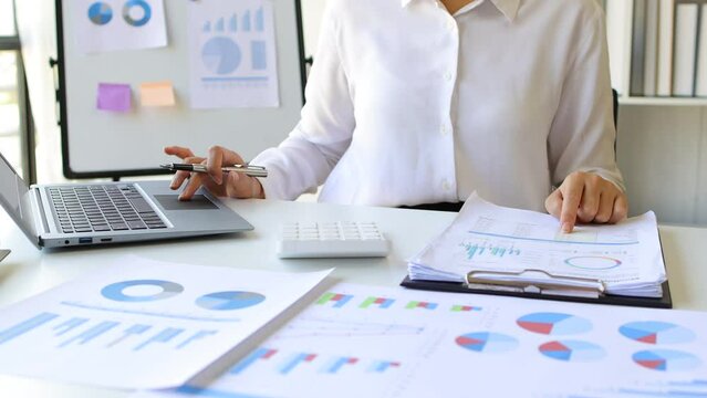 Businesswoman working with documents on desk in office. Accountant auditing documents, calculate budgets and make financial plans.