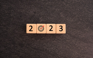 Start Goal in the new year 2023. number 2023 on wooden cubes. good year 2023 with goal plan, goal concept, action plan, strategy, business vision. Business development strategy, advancement
