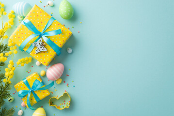 Easter decor concept. Top view photo of bright yellow gift boxes with blue ribbon bows easter eggs...