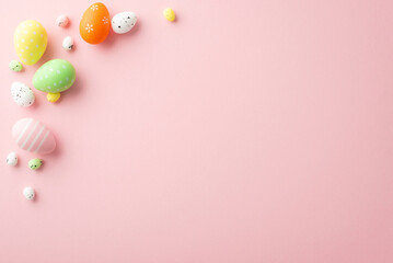 Fototapeta na wymiar Easter concept. Top view photo of orange green yellow easter eggs on isolated light pink background with empty space