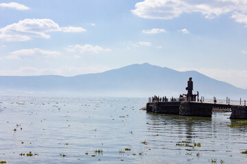 People on a dock by a lake