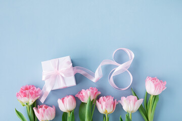 Spring tulip flowers, gift or present box and number 8 for Happy Women Day. Greeting card on blue background.