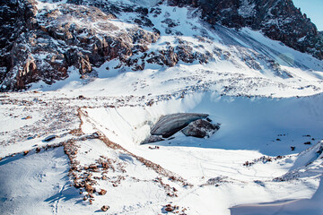 Beautiful ice cave in glacier. Winter mountain landscape.