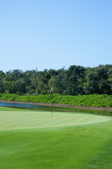 Close-up of the green with flag and water obstacles of a golf club in Mexico