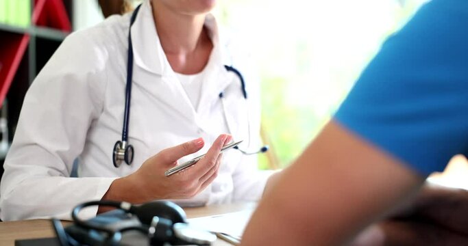 Doctor therapist cardiologist talks with patient, discusses and discusses medical diagnosis