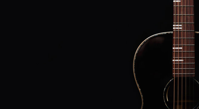 Black acoustic guitar with copy space for text. Professional musical instrument on empty background