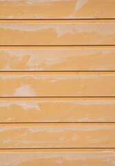 Yellow painted wood panel wall close