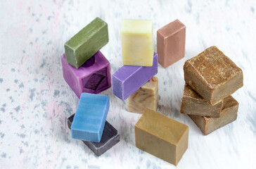 Homemade soaps. Variety of colorful handmade soap bars on wooden background