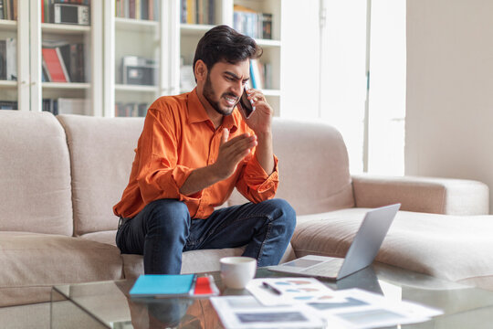 Angry Middle Eastern Businessman Working From Home, Have Phone Call